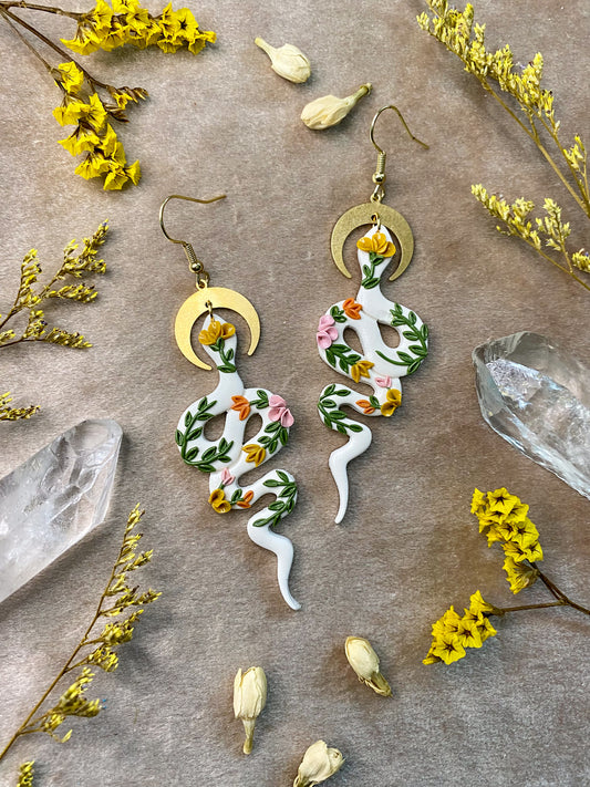 polymer clay white and floral snake dangle earrings