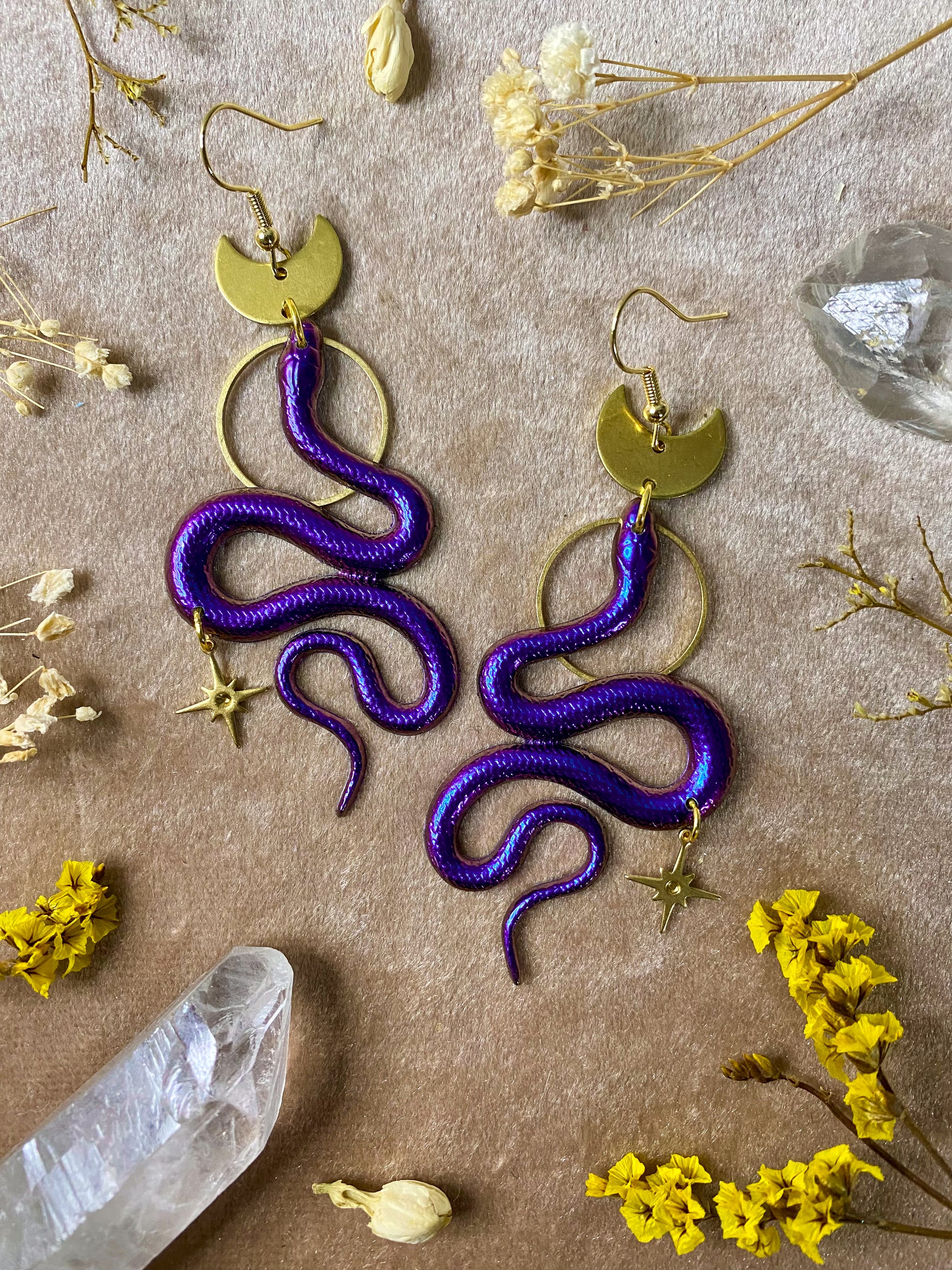 purple and magenta resin twinkle celestial dangle snake earrings